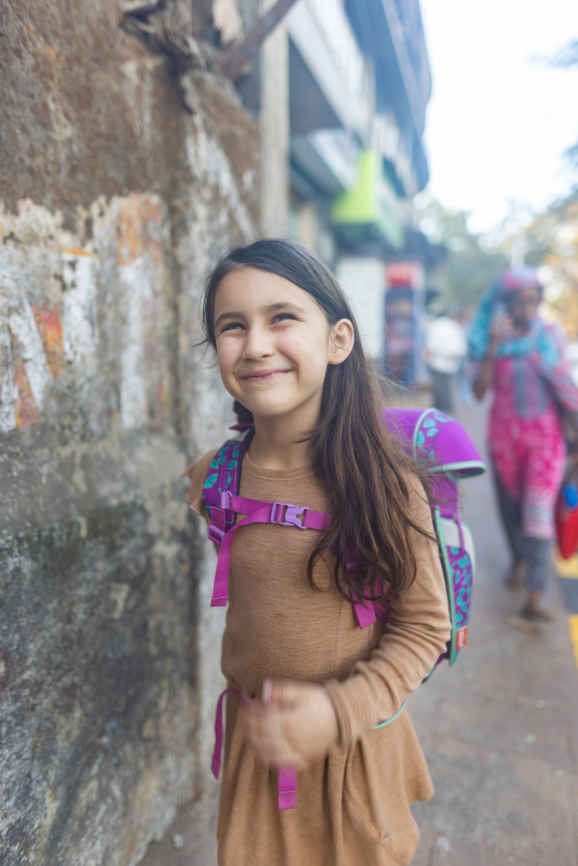 Smiling Girl with Backpack on Street