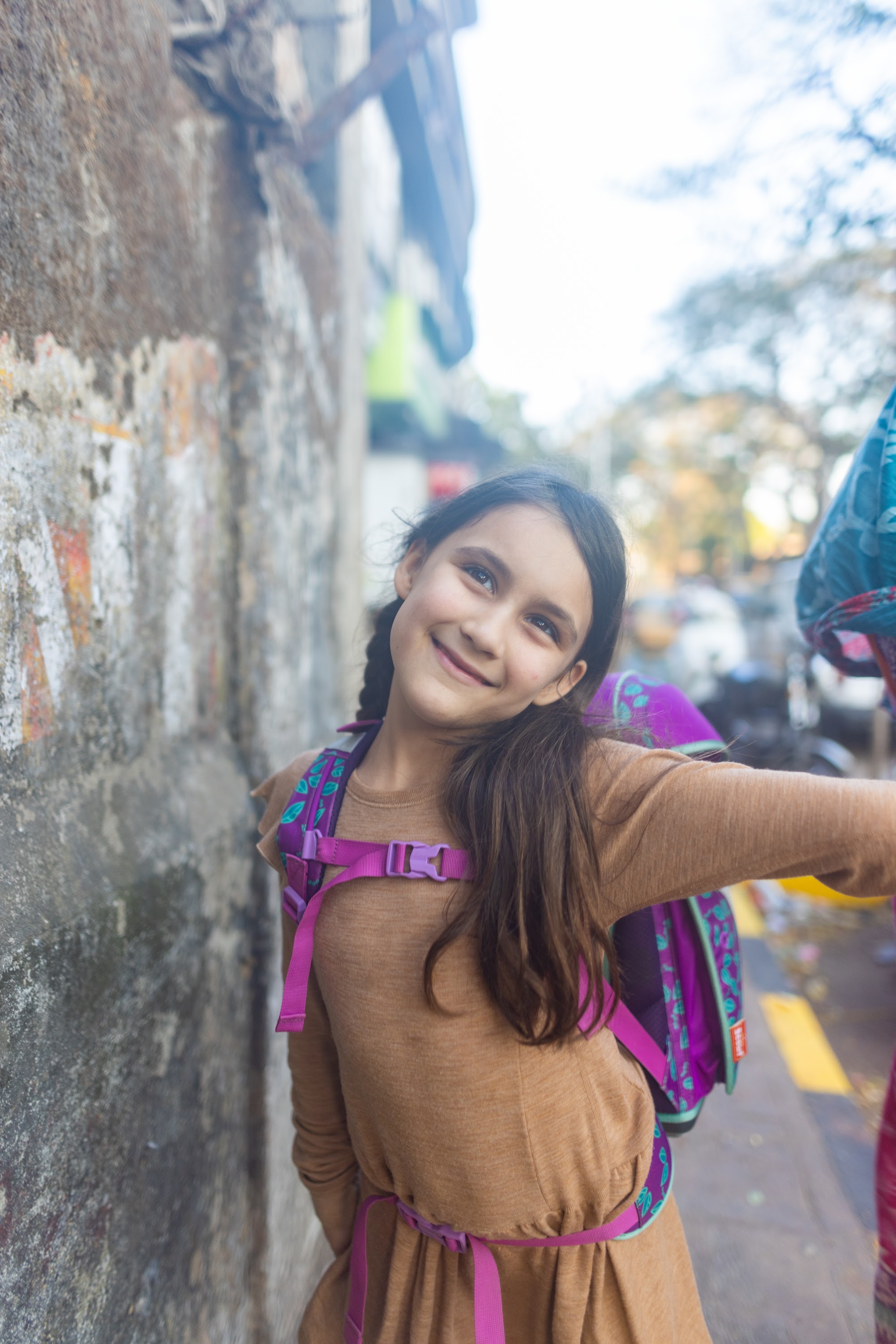 Smiling Girl with Backpack on Street
