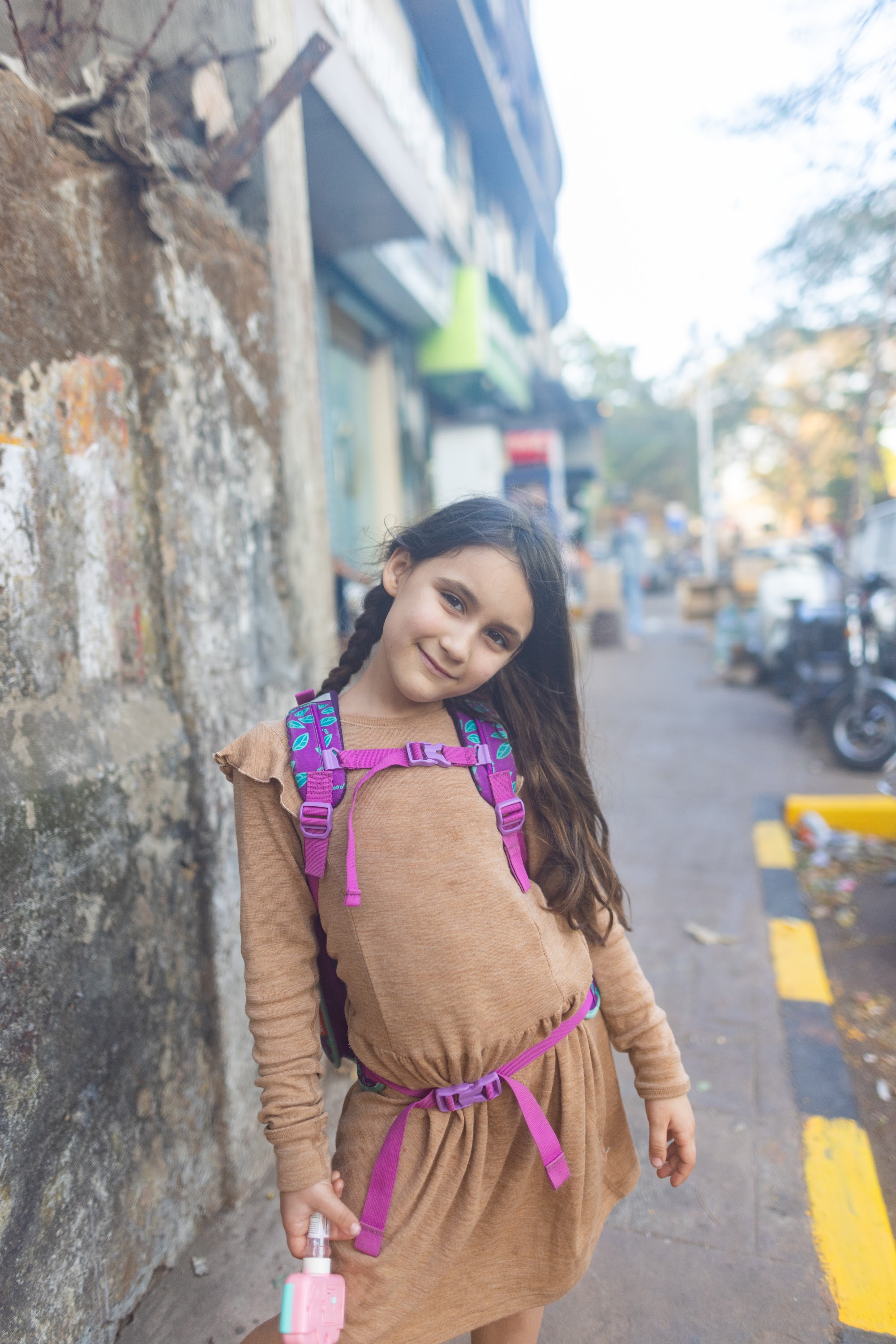 Girl with Purple Backpack on Street
