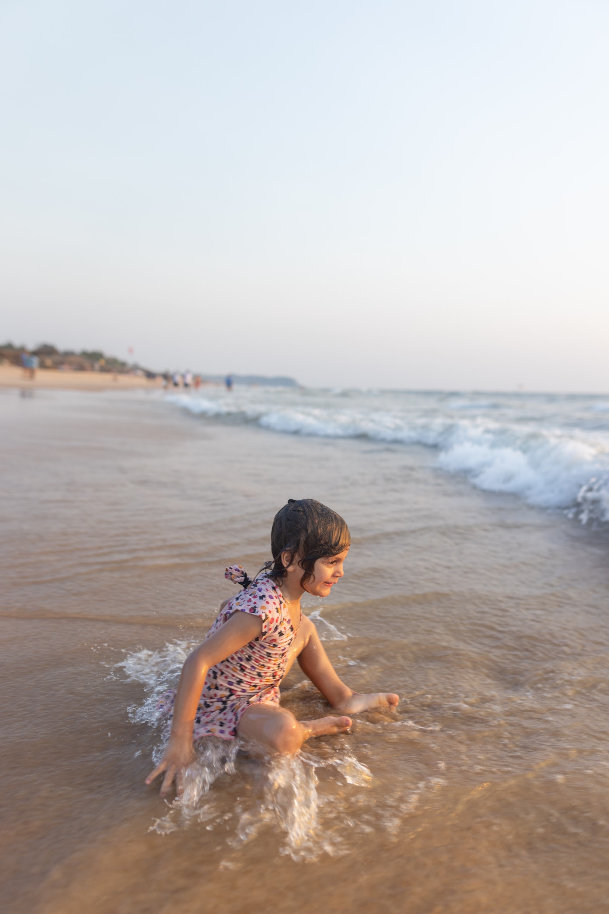 Child Playing in Ocean Waves at Beach