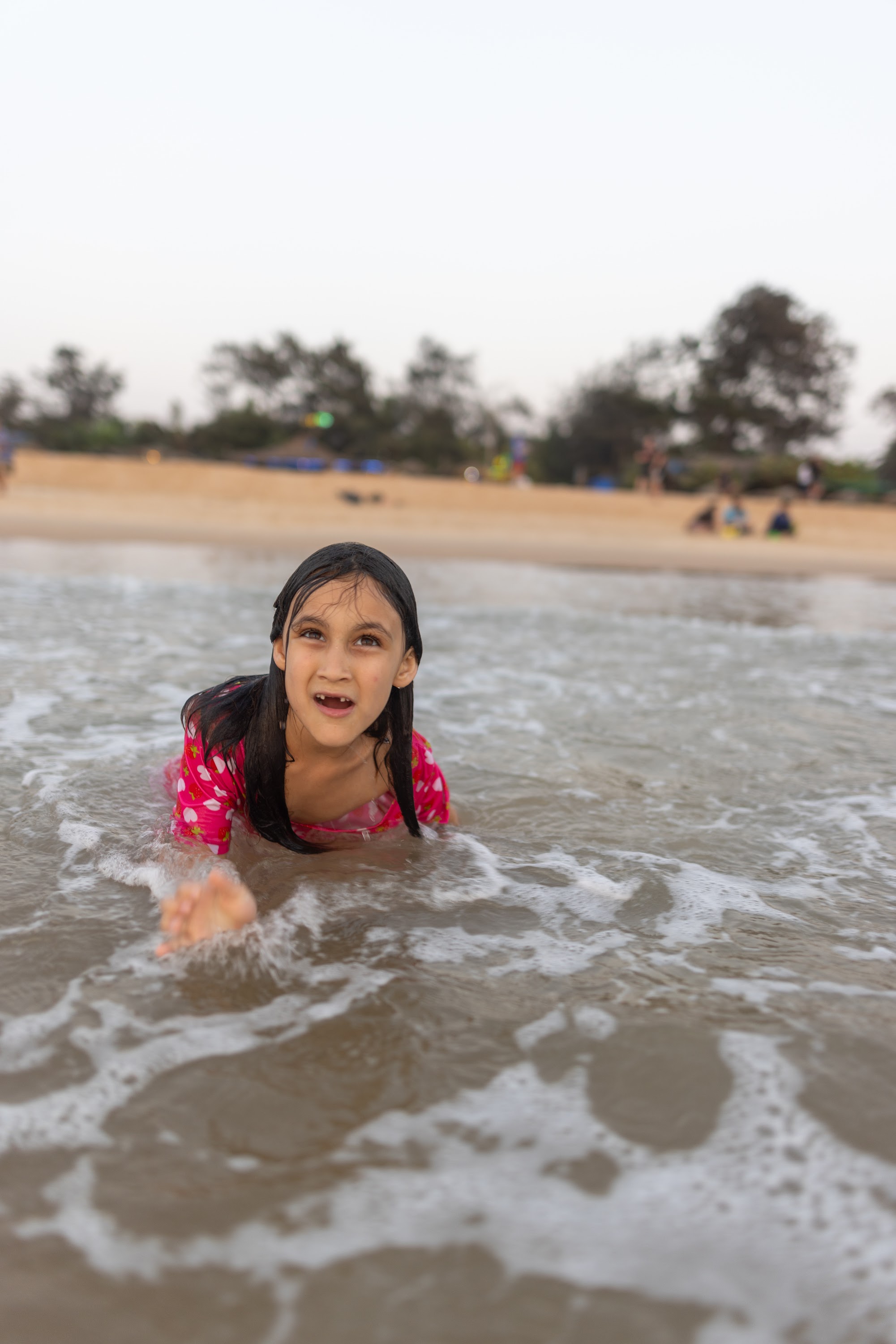 Girl Playing in Ocean Waves at Beach
