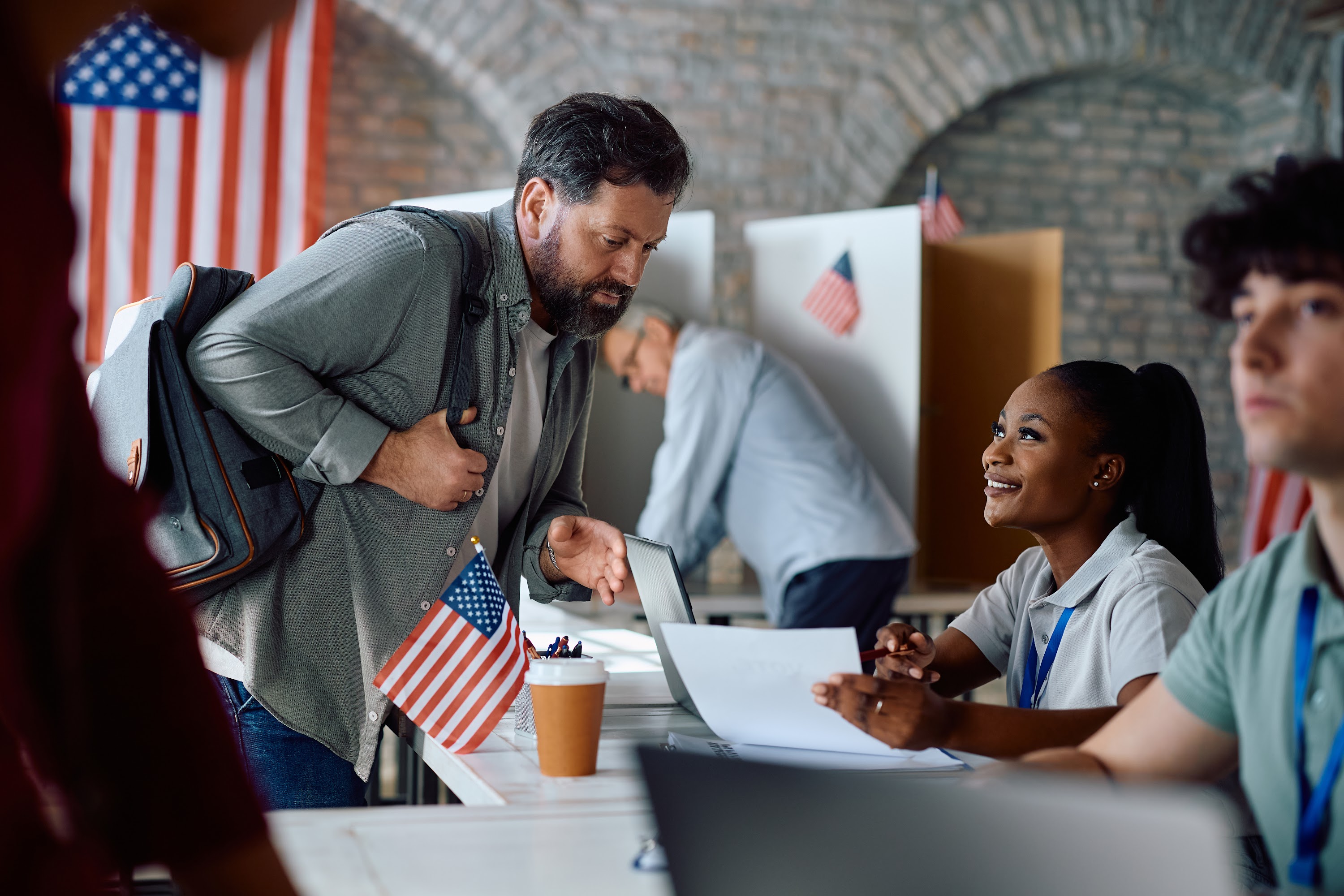 happy-black-volunteer-talking-to-a-voter-during-us-2024-02-29-05-12-43-utc.jpg