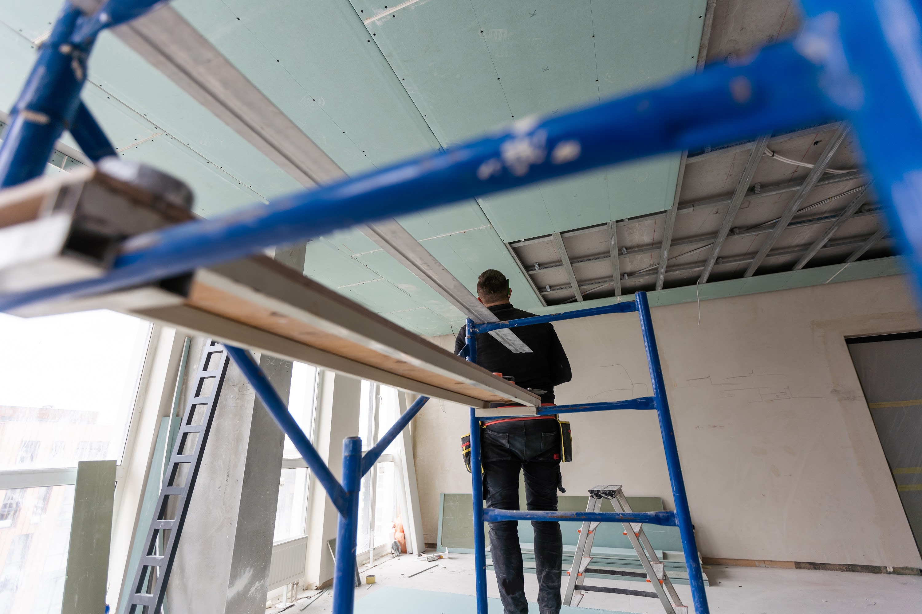 drywall-installers-men-holding-a-gypsum-board-fig-2023-11-27-05-36-25-utc.jpg