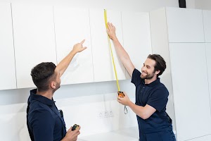 worker-pointing-with-finger-near-colleague-measuri-2023-11-27-05-06-25-utc.jpg
