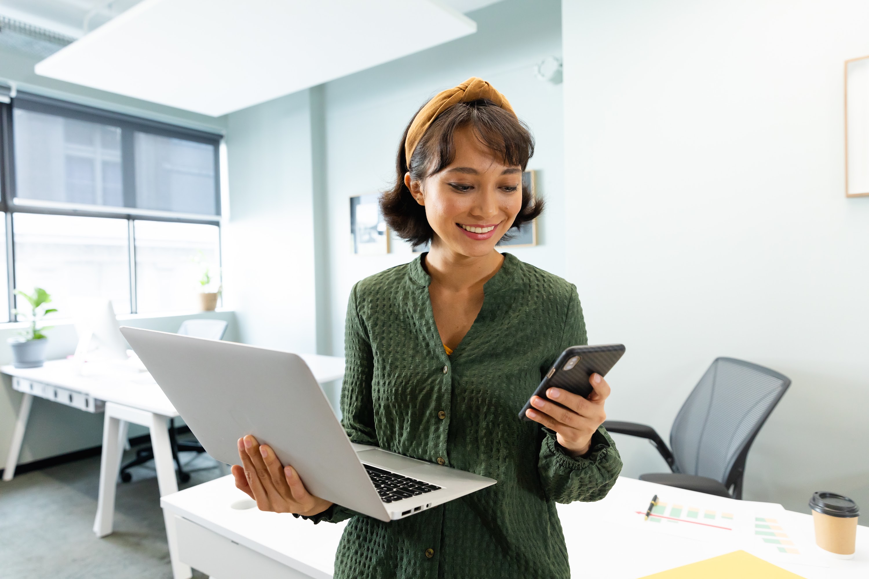 asian-female-architect-with-laptop-using-smart-pho-2023-11-27-05-24-46-utc.jpg