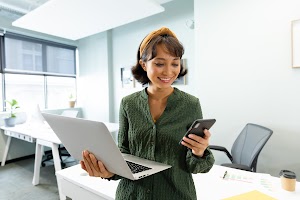 asian-female-architect-with-laptop-using-smart-pho-2023-11-27-05-24-46-utc.jpg