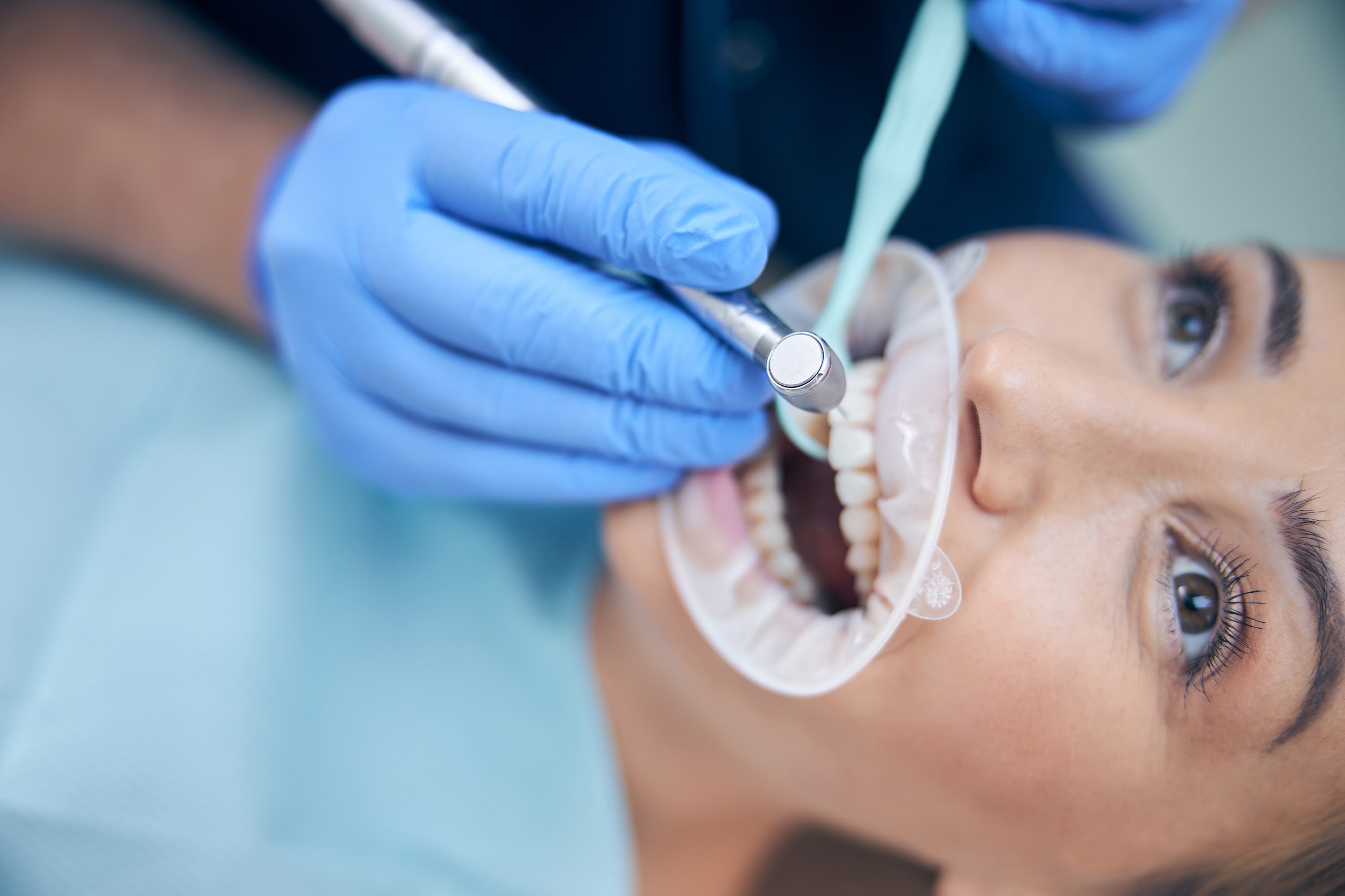 dentist-treating-young-beautiful-female-in-office-2023-11-27-05-34-49-utc.jpg