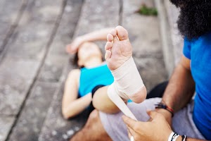 man-wrapping-foot-of-woman-in-bandage-2023-11-27-05-02-16-utc.jpg