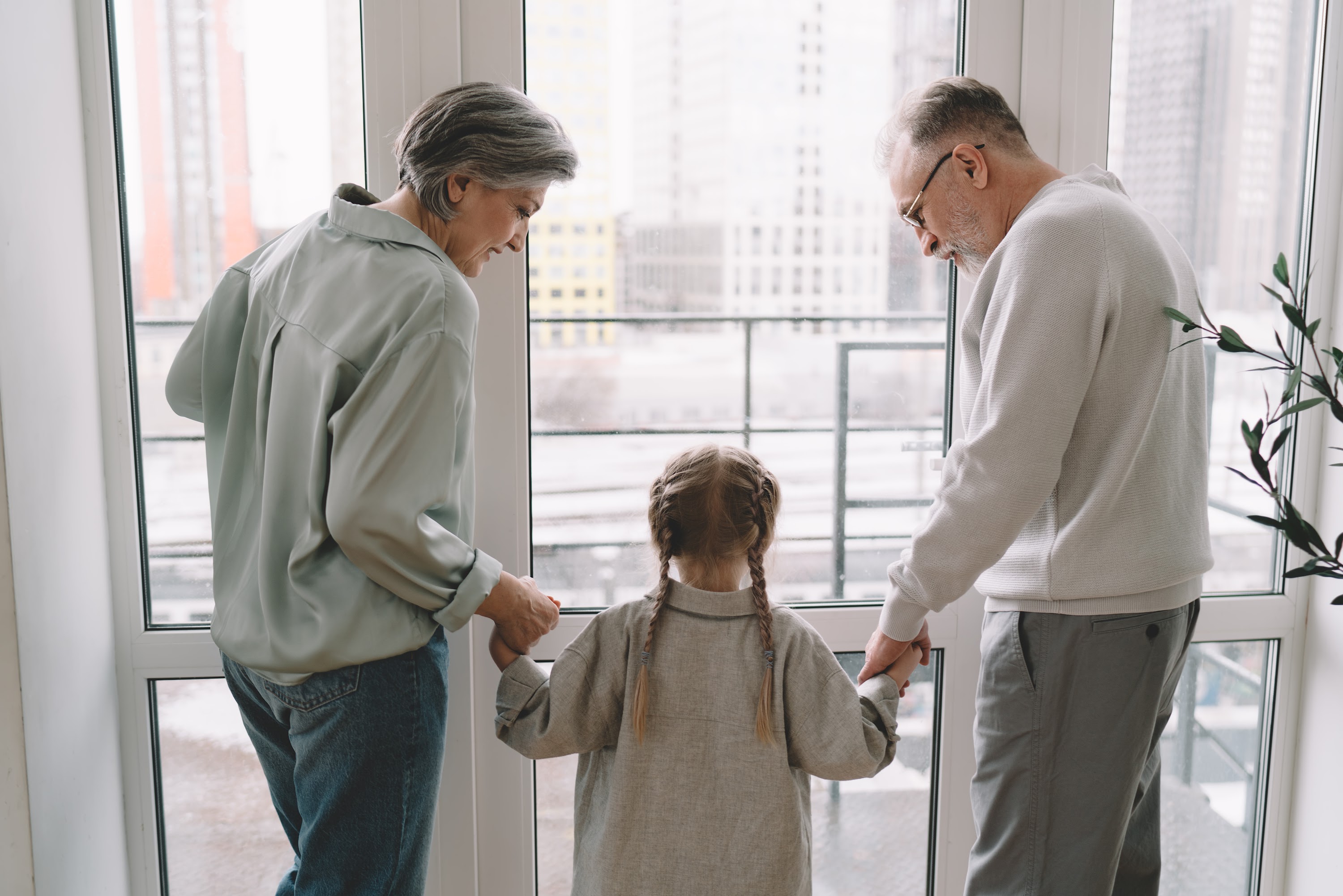 senior-couple-with-granddaughter-near-glass-doorwa-2024-05-08-23-54-16-utc.jpg