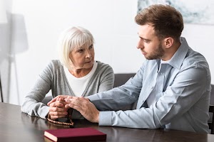senior-woman-with-rosary-holding-hands-with-son-2023-11-27-04-52-09-utc.jpg