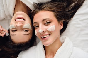 two-women-in-bathrobes-lying-near-in-bed-with-cosm-2023-11-27-05-01-14-utc.jpg