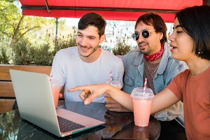 three-young-friends-using-laptop-at-coffee-shop-2023-11-27-04-59-44-utc.JPG