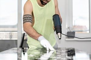 a-man-renovating-an-old-table-attaching-an-adhesi-2023-11-27-05-06-04-utc.jpg
