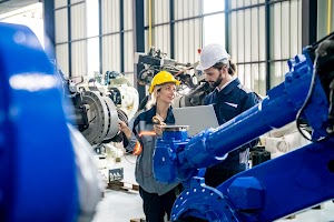 engineer-with-robot-in-automotive-parts-factory-2023-11-27-04-58-15-utc.jpg