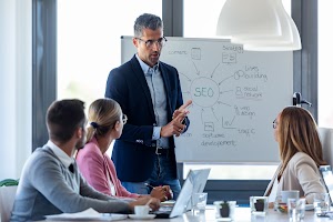 handsome-businessman-explaining-a-project-to-his-c-2024-02-23-05-03-45-utc.jpg