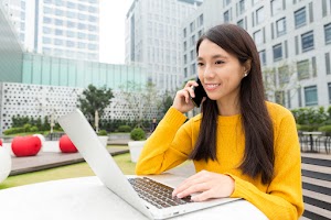 young-woman-chatting-on-cellphone-with-laptop-comp-2023-11-27-05-34-24-utc.jpg