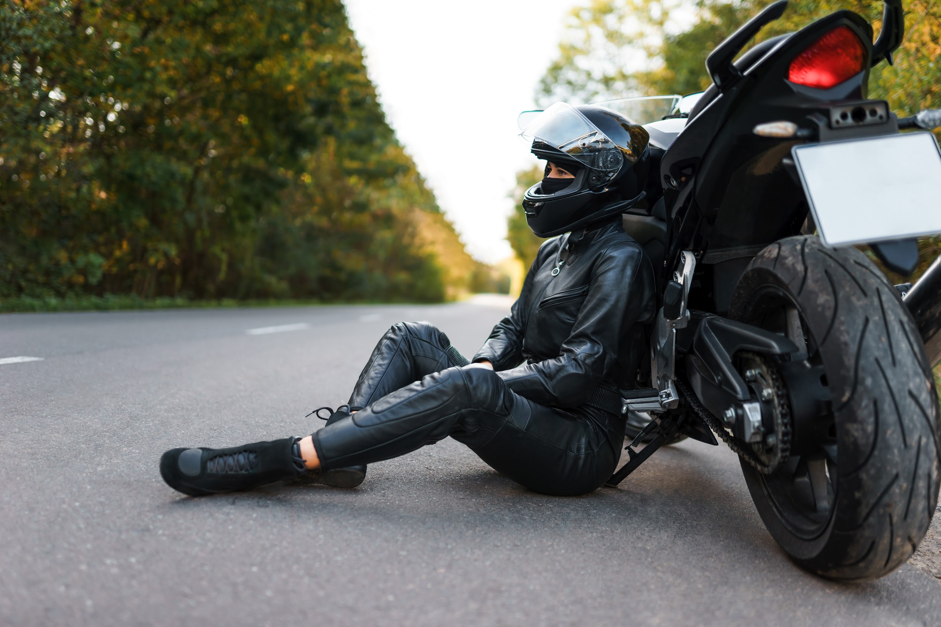 biker-girl-in-black-outfit-sits-leaning-on-a-motor-2023-11-27-05-36-19-utc.jpg