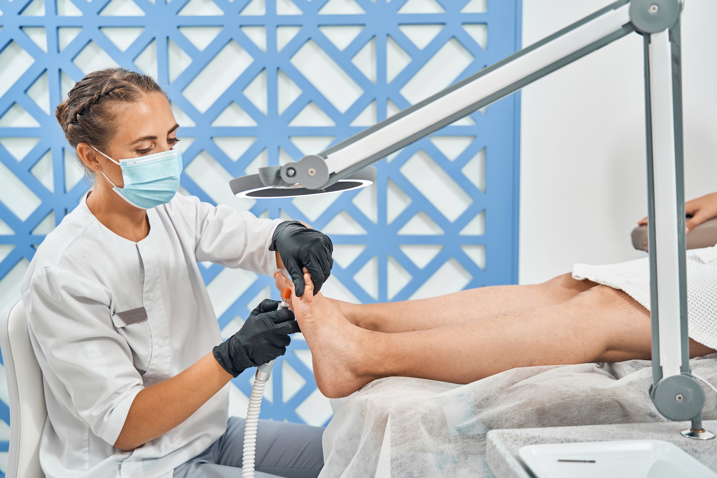 close-up-of-serious-podologist-removing-rough-skin-2023-11-27-05-21-11-utc.jpg