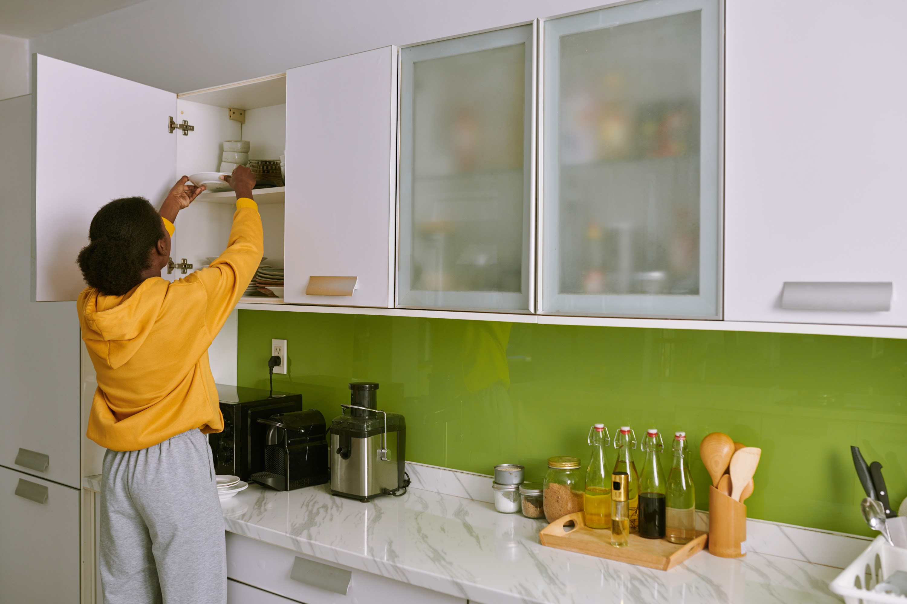 woman-taking-plate-out-of-cabinet-2023-11-27-05-04-55-utc.jpg
