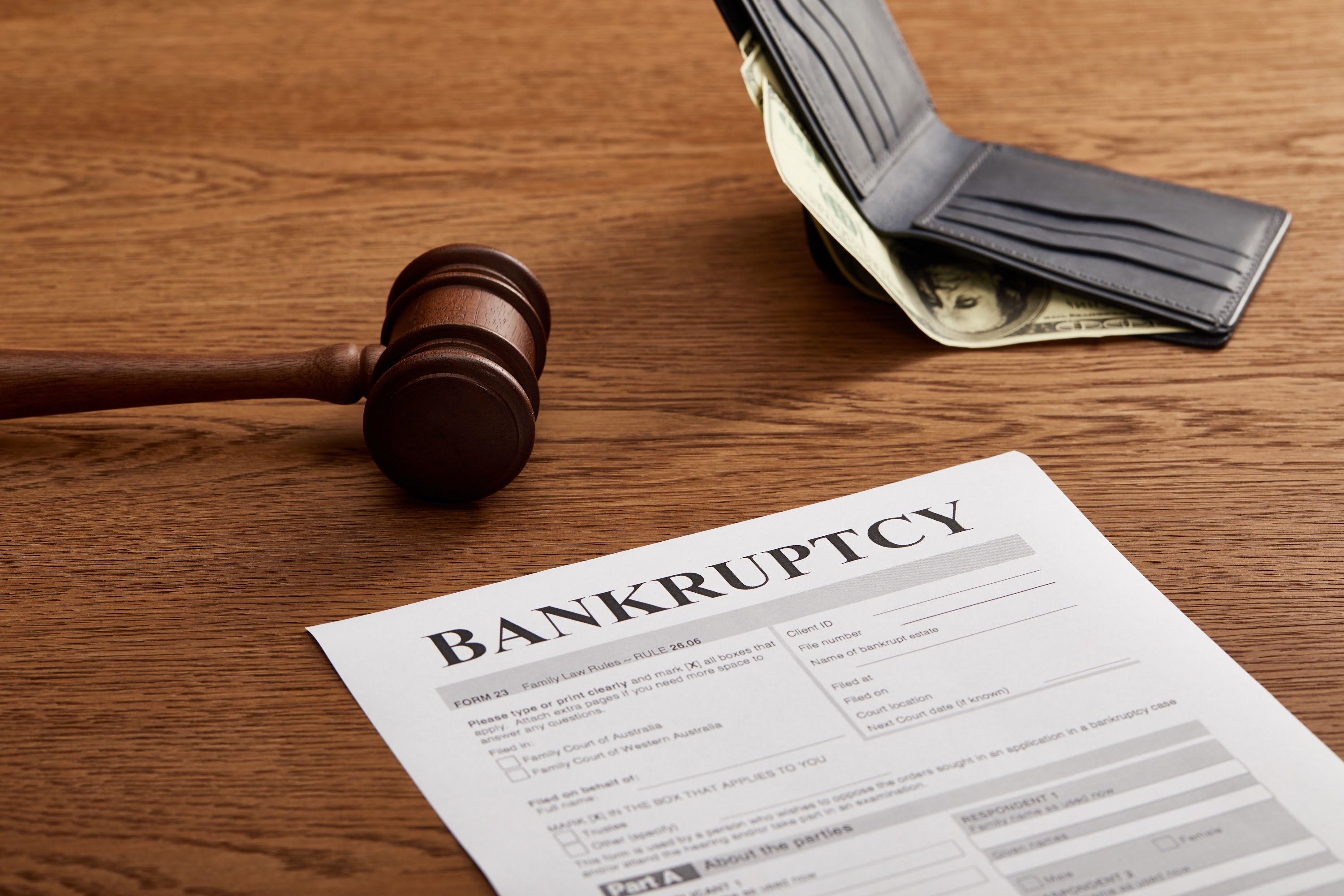bankruptcy-form-with-wooden-gavel-dollar-banknote-2023-11-27-04-52-43-utc.jpg