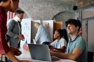 happy-volunteer-assisting-voters-during-elections-2024-02-29-02-52-13-utc.jpg