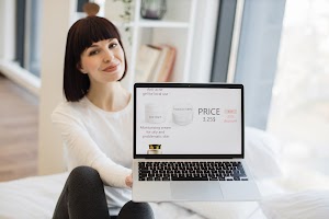 woman-showing-laptop-with-cosmetic-store-on-screen-2023-11-27-05-06-47-utc.jpg