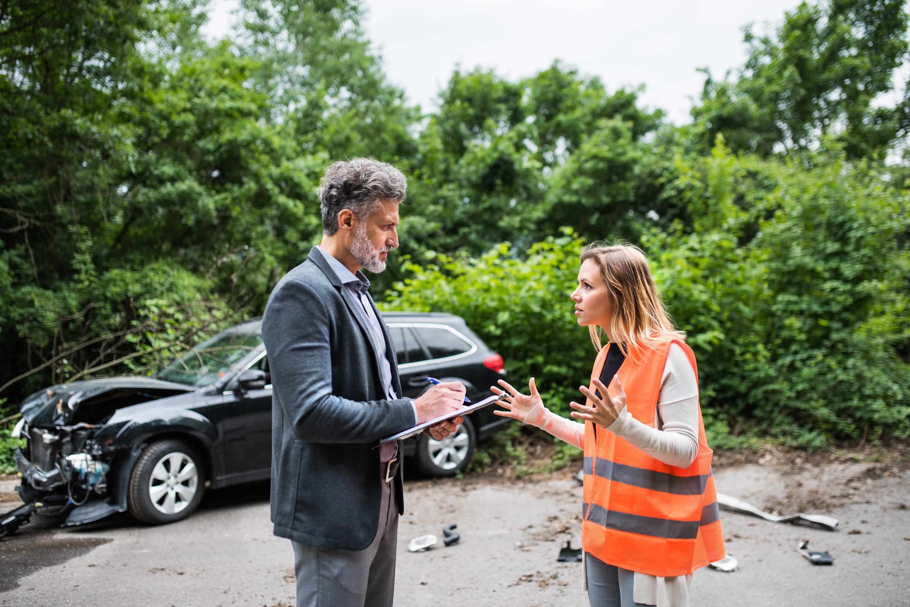 an-insurance-agent-talking-to-a-woman-driver-by-th-2024-10-20-18-07-55-utc.jpg