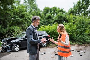 an-insurance-agent-talking-to-a-woman-driver-by-th-2024-10-20-18-07-55-utc.jpg