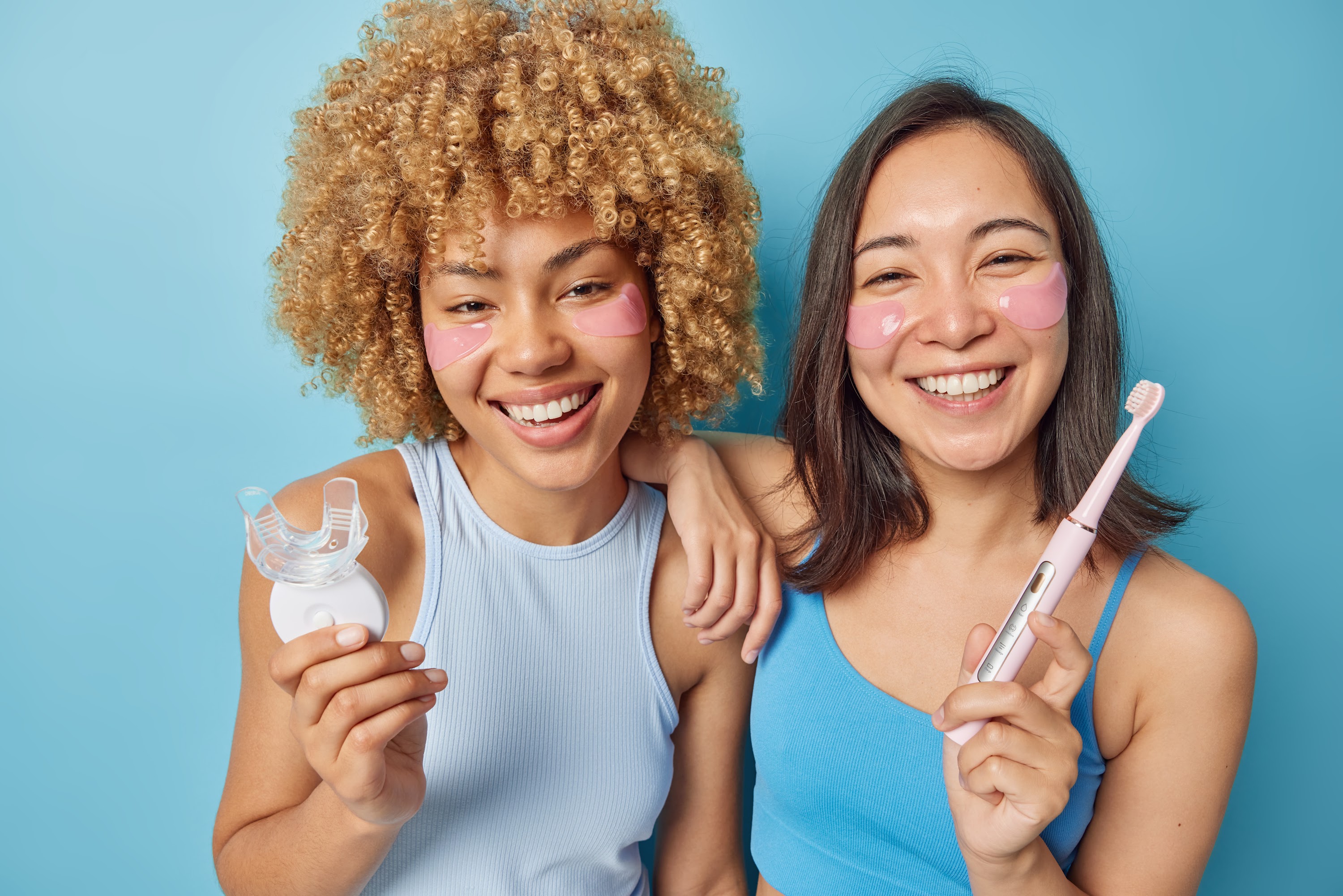 happy-mixed-race-young-women-hold-mouth-expander-a-2023-11-27-05-25-34-utc.jpg