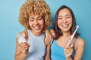 happy-mixed-race-young-women-hold-mouth-expander-a-2023-11-27-05-25-34-utc.jpg