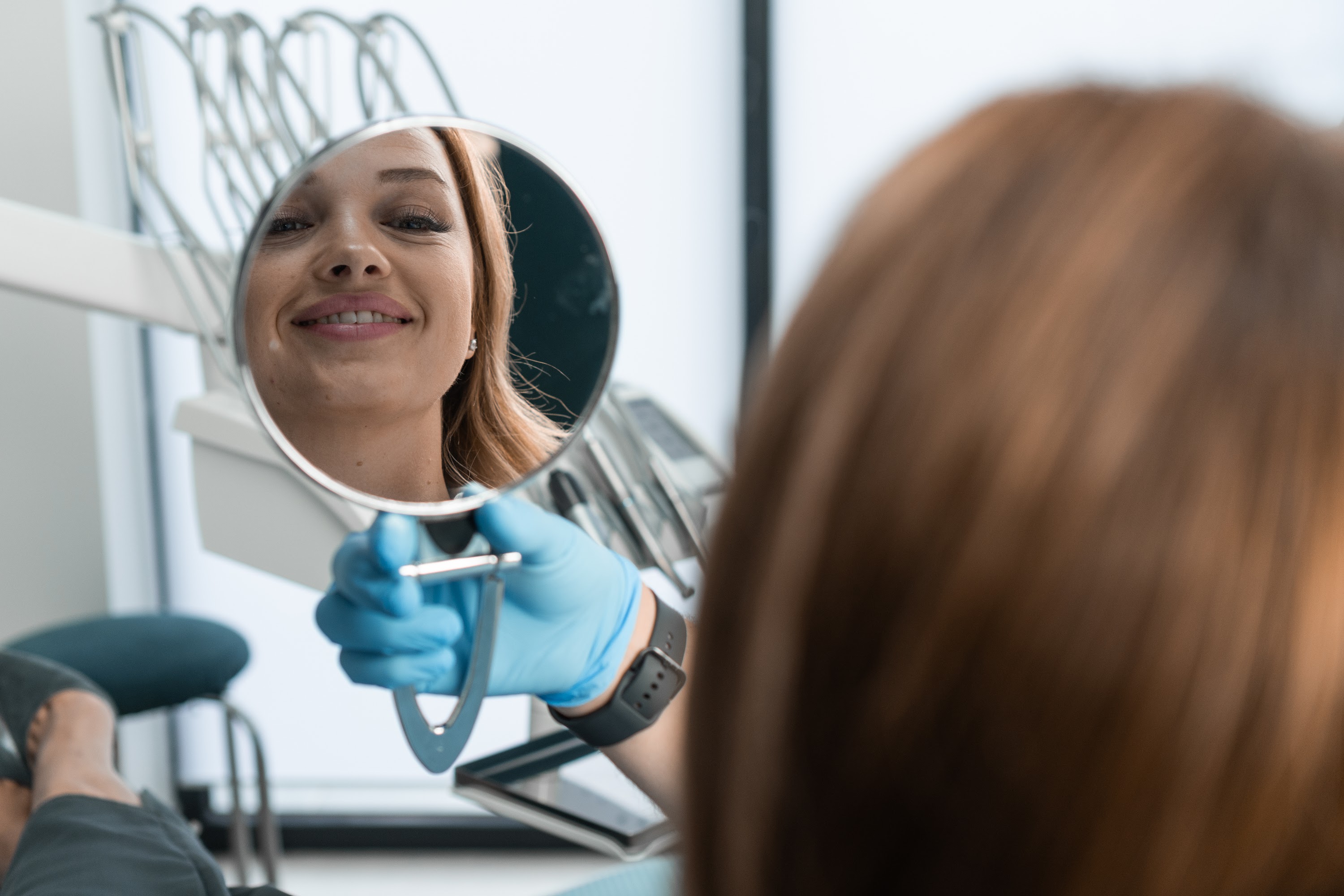 in-the-dental-chair-the-patient-holds-the-mirror-2024-10-17-02-44-53-utc.jpg