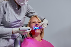 dentist-using-ultraviolet-light-on-the-patient-s-t-2024-10-14-05-16-16-utc.jpg