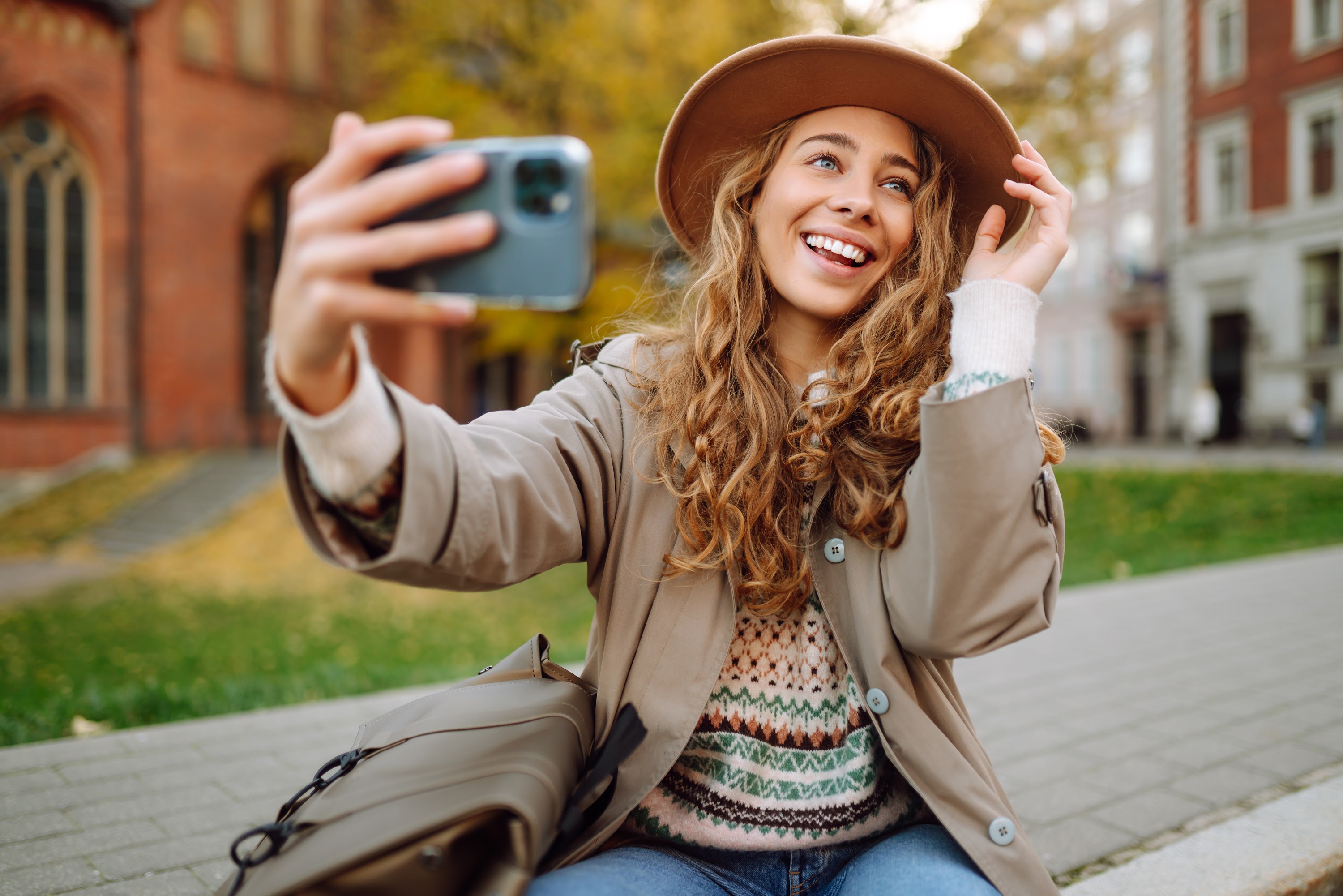stylish-woman-in-a-raincoat-and-hat-takes-a-selfie-2023-11-27-05-26-00-utc.jpg