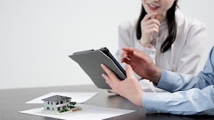 men-and-women-looking-at-real-estate-information-o-2024-12-06-18-38-11-utc.jpg