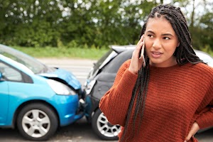 female-motorist-involved-in-car-accident-calling-i-2024-10-19-04-23-21-utc.jpg