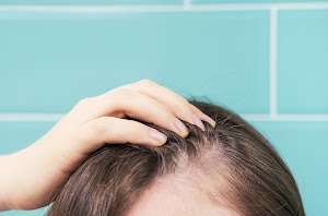 woman-touching-her-hair-close-up-on-against-backgr-2025-01-10-11-23-20-utc.jpg