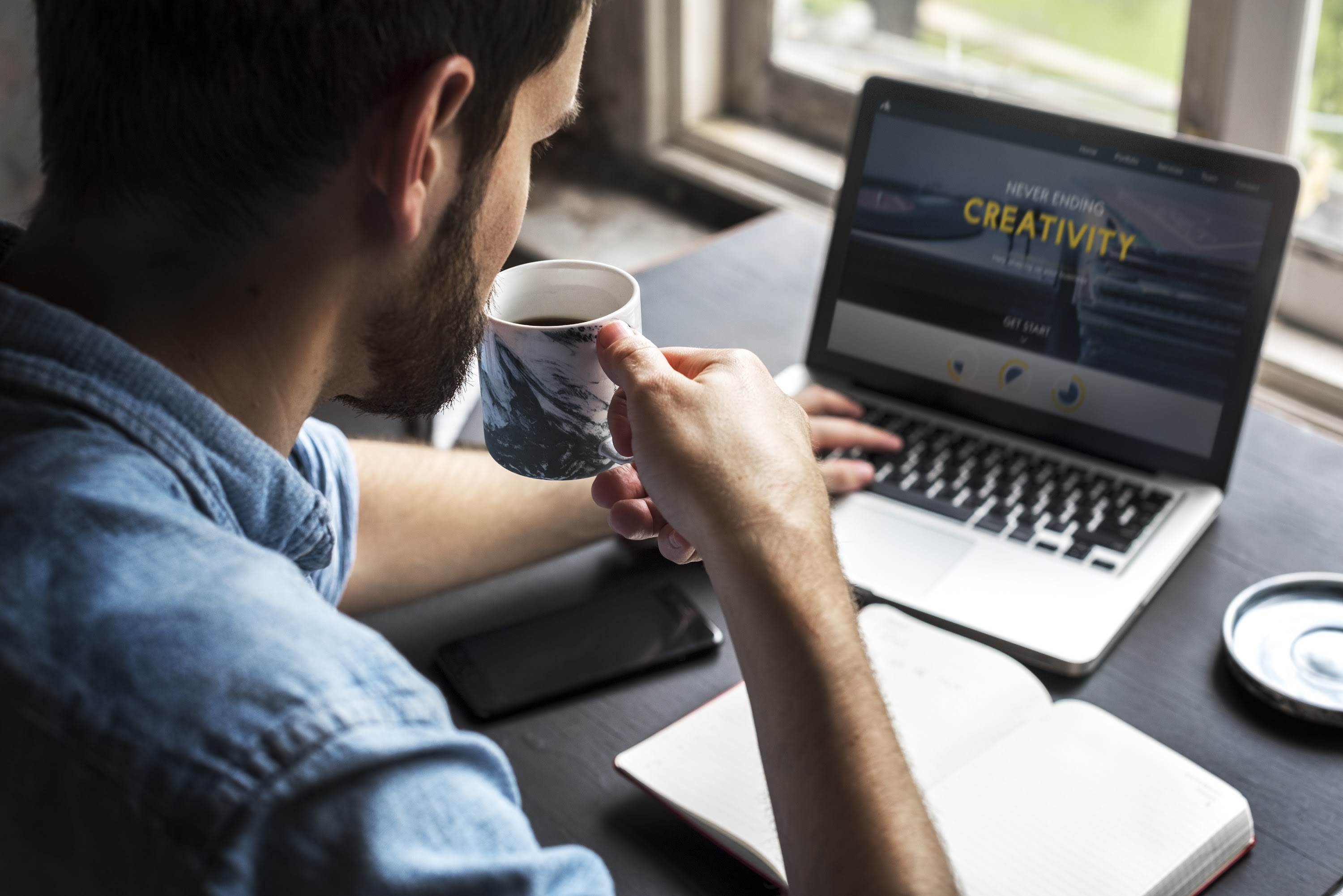 man-sipping-coffee-while-working-on-laptop-2025-02-11-05-32-01-utc.jpg