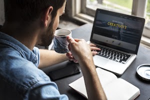 man-sipping-coffee-while-working-on-laptop-2025-02-11-05-32-01-utc.jpg
