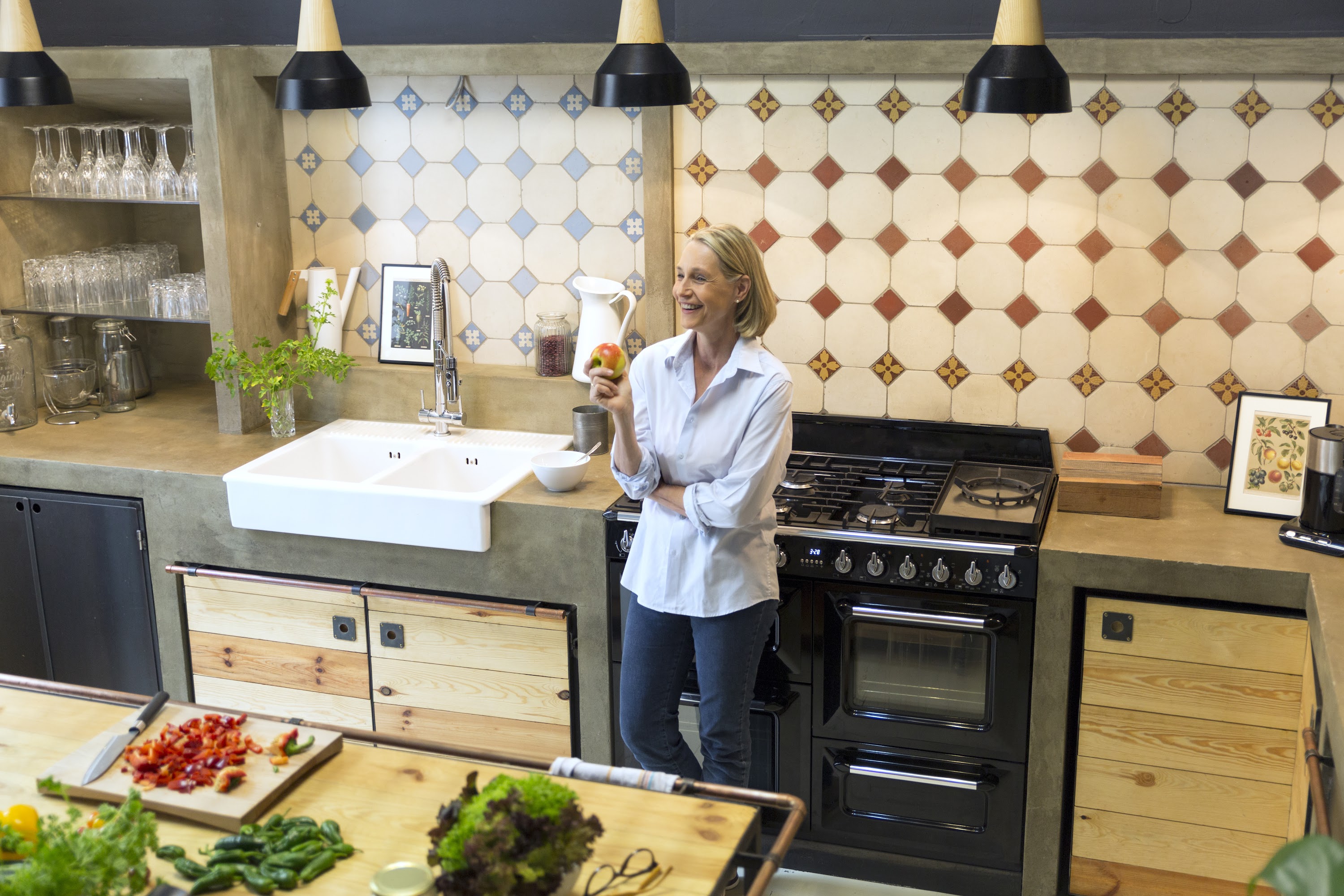 smiling-mature-woman-holding-an-apple-in-kitchen-2024-09-17-15-15-36-utc.jpg