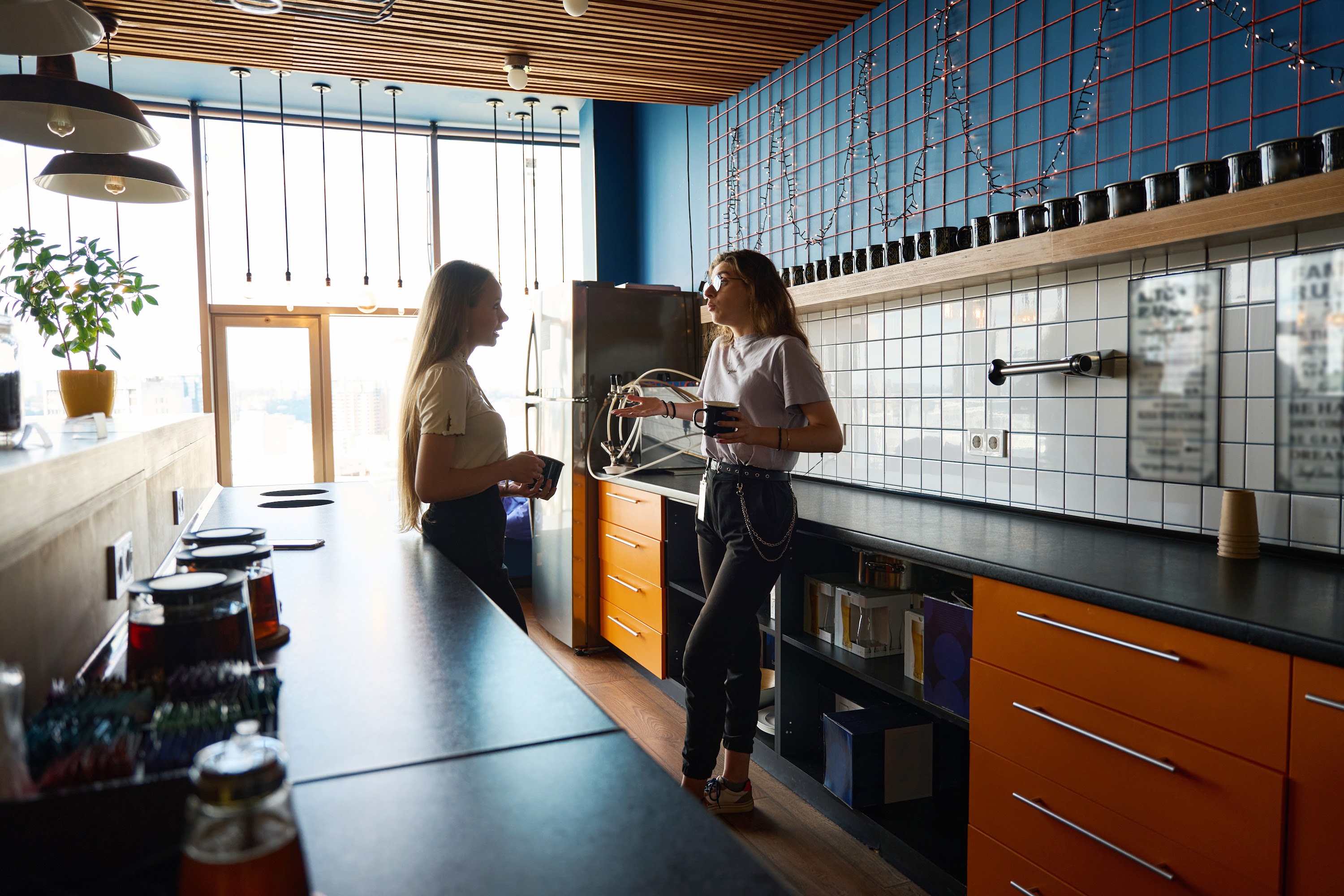 woman-stands-with-friend-in-kitchen-and-shrugs-her-2024-10-20-11-34-30-utc.jpeg