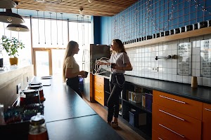 woman-stands-with-friend-in-kitchen-and-shrugs-her-2024-10-20-11-34-30-utc.jpeg