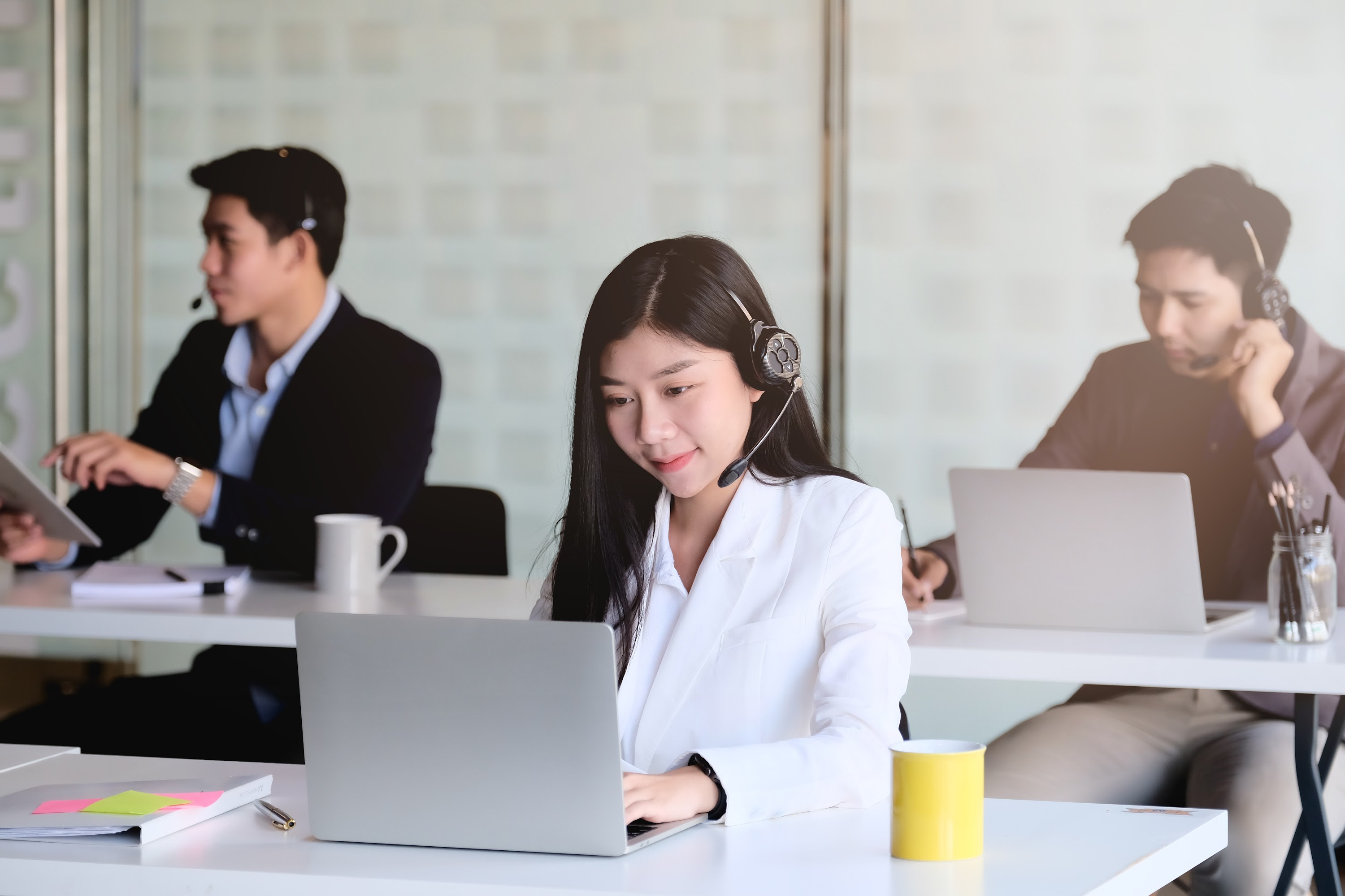 young-asian-woman-working-in-call-centre-surround-2025-01-10-11-22-18-utc.jpg