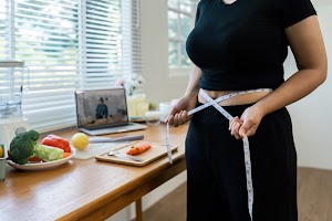 overweight-asian-woman-measuring-her-hip-while-lea-2025-02-18-09-01-52-utc.jpg