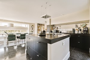 a-large-kitchen-with-an-island-and-a-dining-room-2025-02-10-13-29-23-utc.jpg
