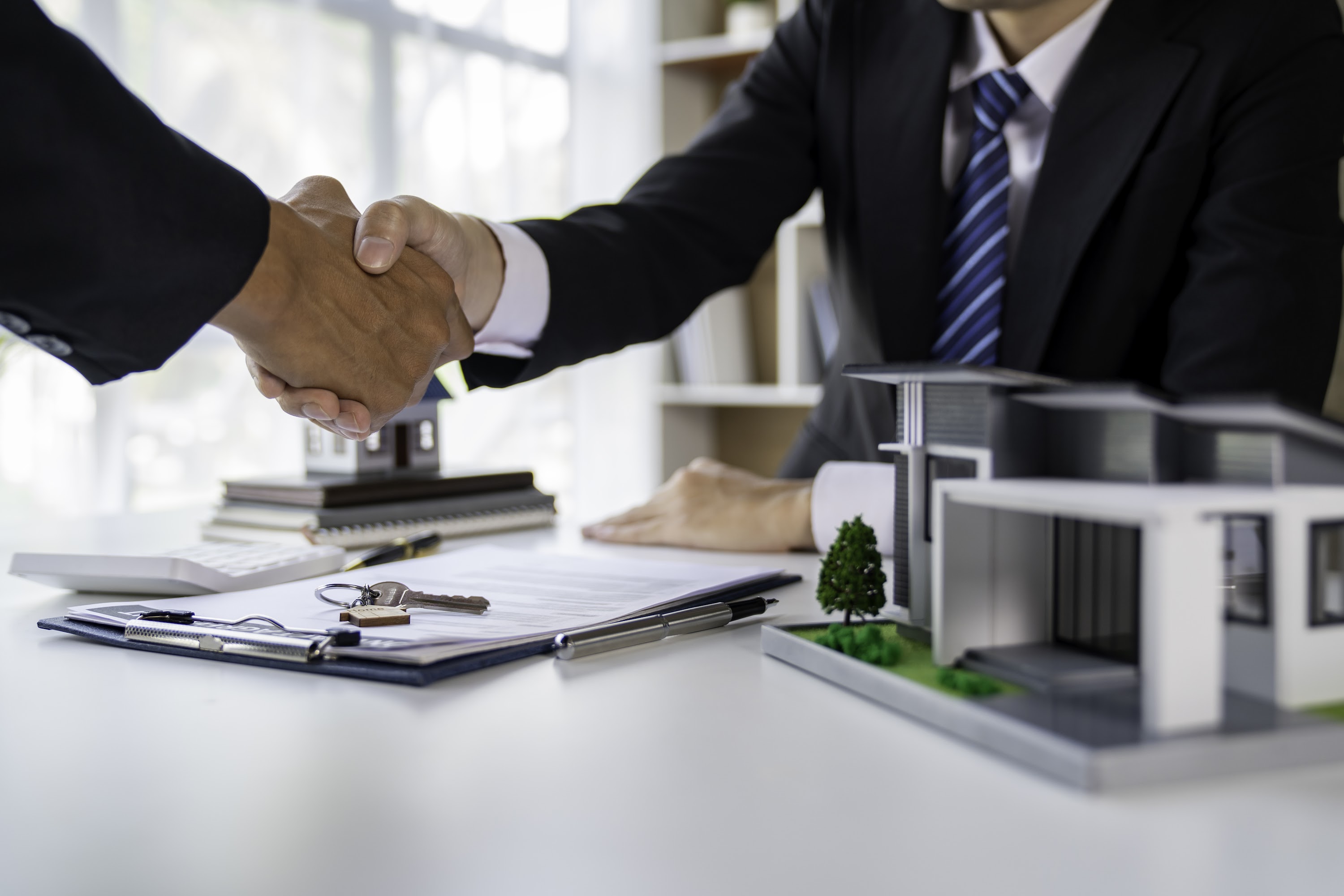 real-estate-agent-and-customers-shaking-hands-toge-2025-02-18-05-57-12-utc.jpg