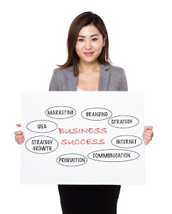 asian-businesswoman-holding-a-poster-presenting-bu-2025-03-26-08-15-08-utc.jpg
