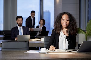 smiling-ethnic-businesswoman-at-table-in-office-2025-01-31-06-37-32-utc.jpg