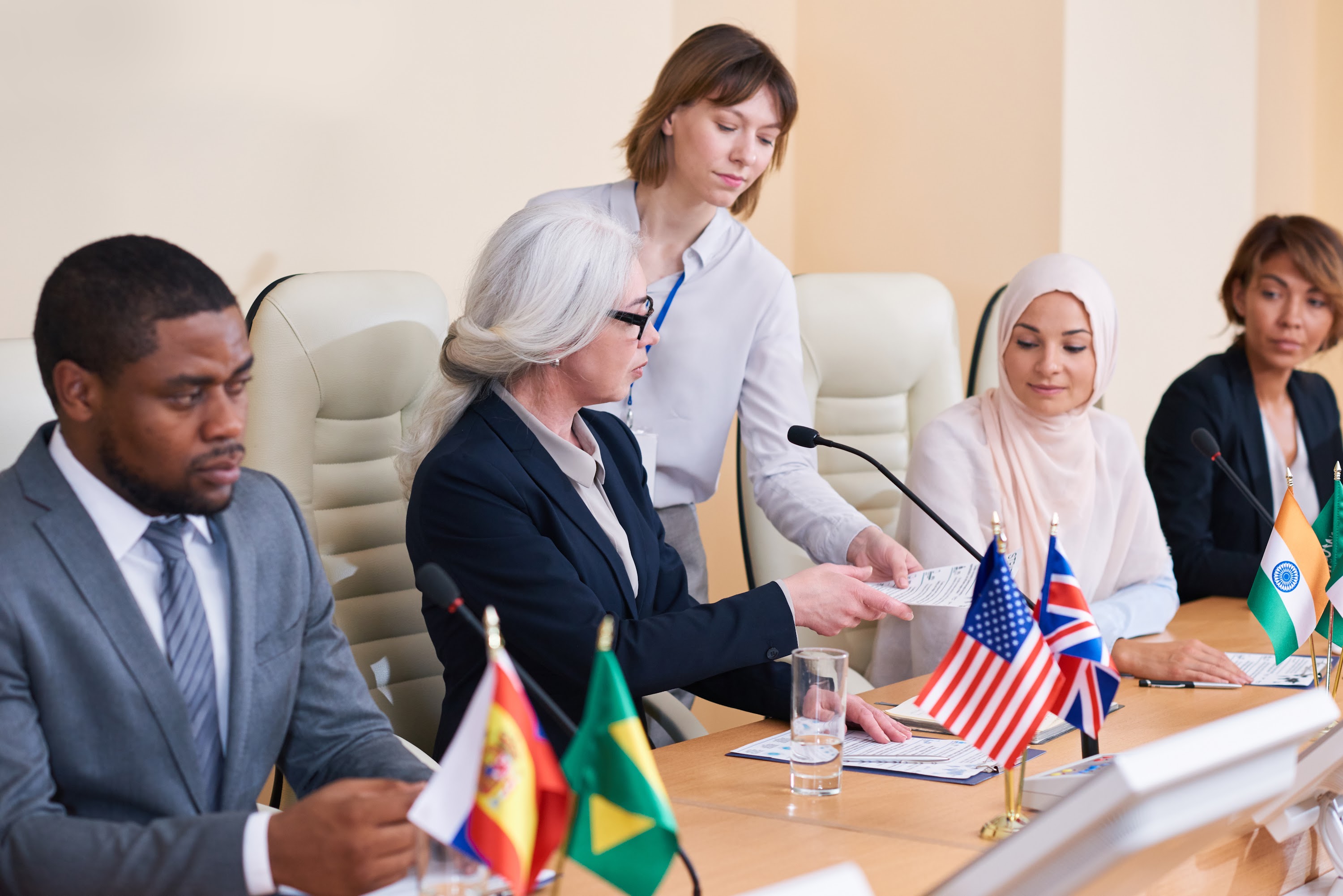 young-secretary-giving-documents-to-one-of-intercu-2025-03-15-14-19-07-utc.jpg
