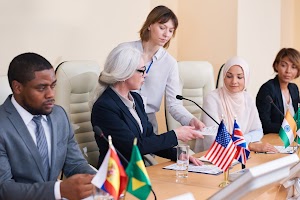 young-secretary-giving-documents-to-one-of-intercu-2025-03-15-14-19-07-utc.jpg