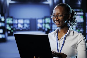 woman-in-data-center-with-laptop-2025-02-20-06-08-57-utc.jpg